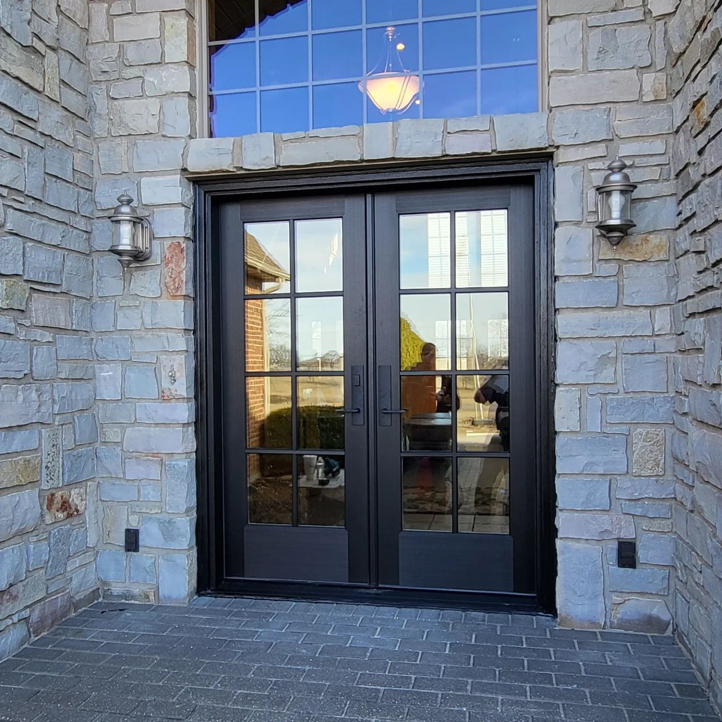 A brick building with a black door and a window