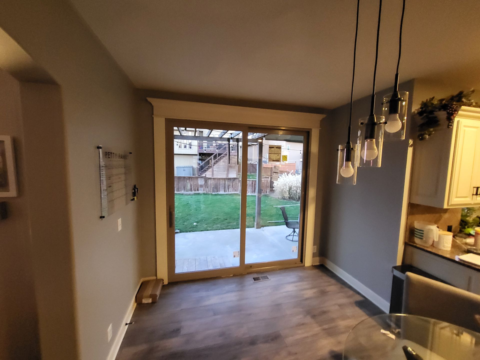 A dining room with a sliding glass door leading to a patio.