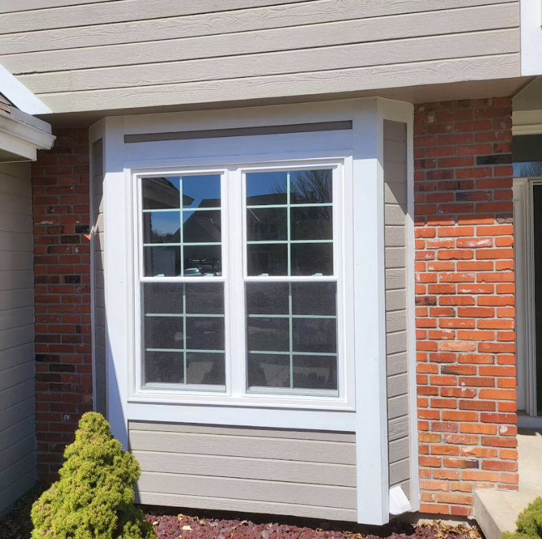 A window on the side of a brick house