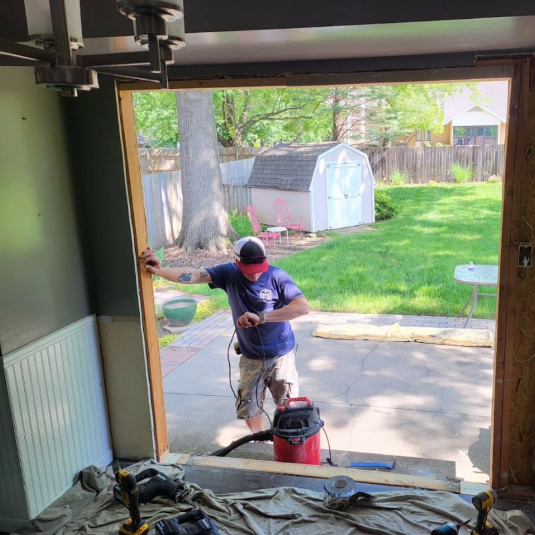 A man is working on a garage door.