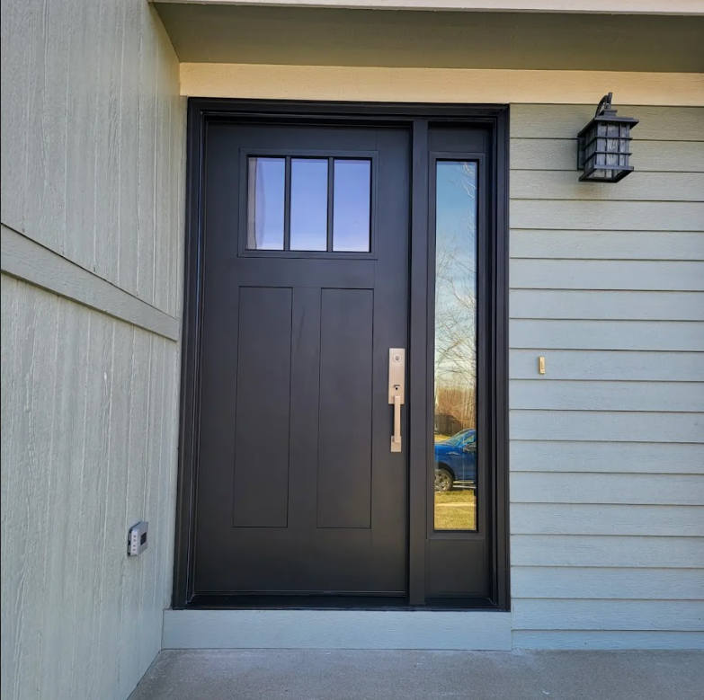 A black door with a light on the side of it
