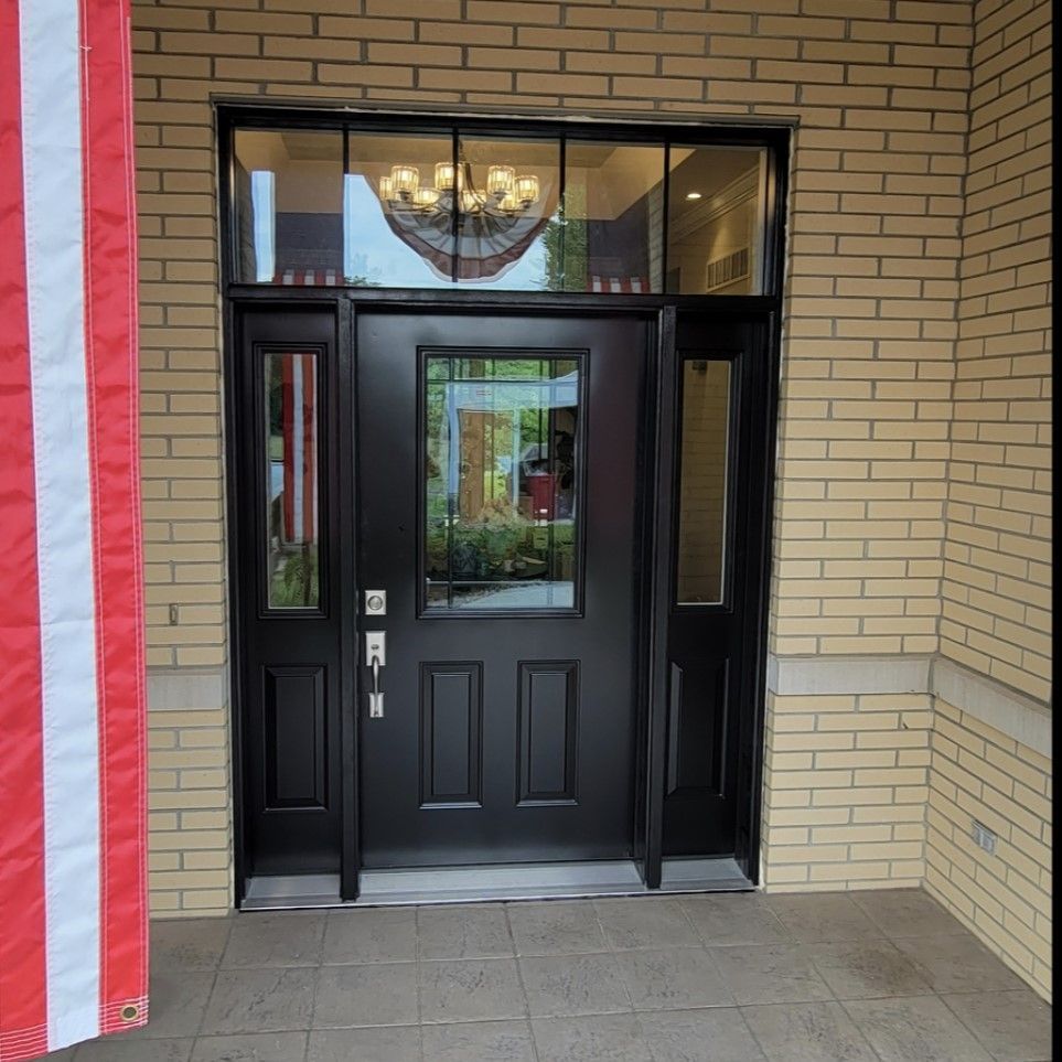 The front door of a brick building with a black door