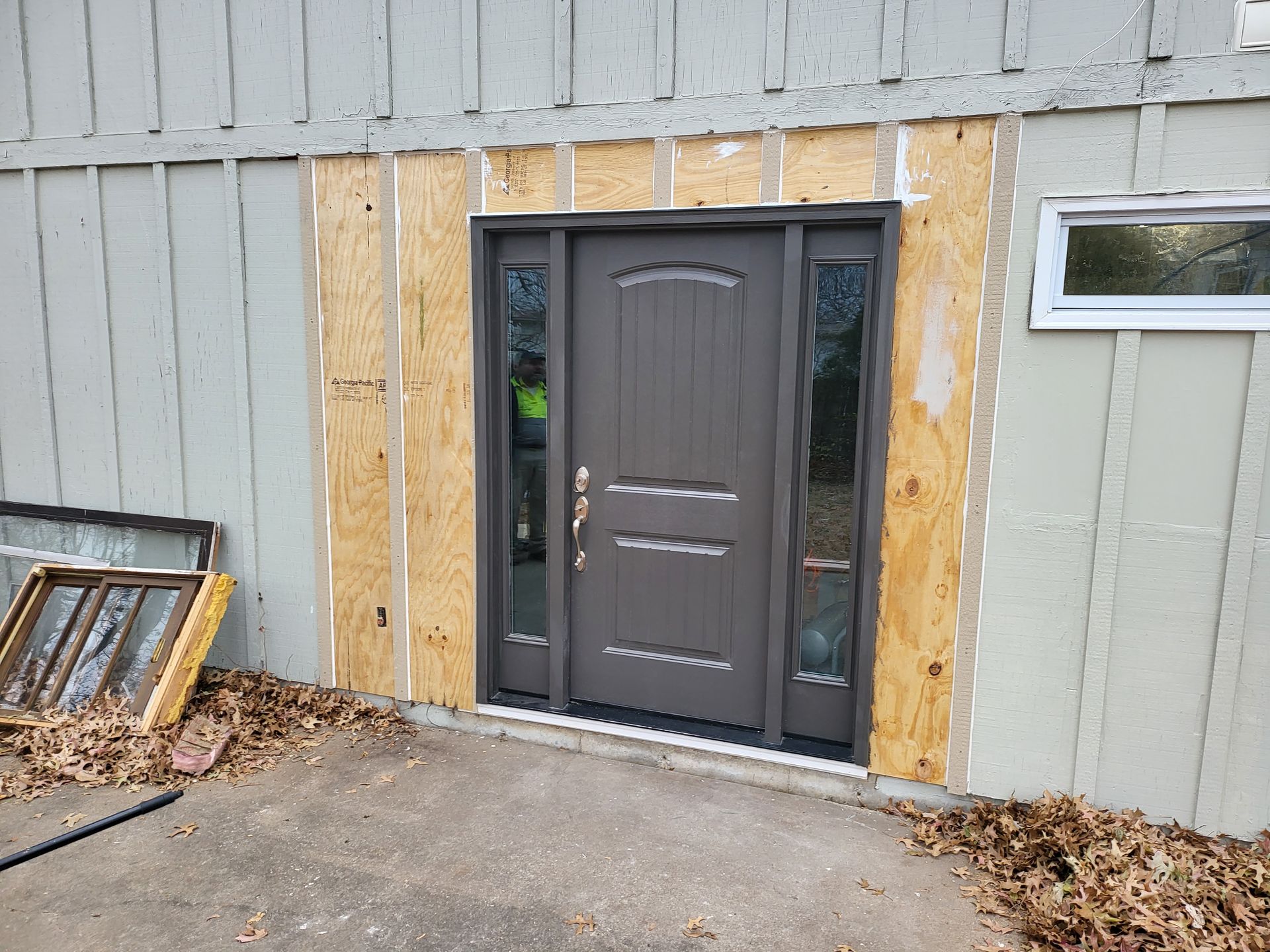 A door is being installed on the side of a house.