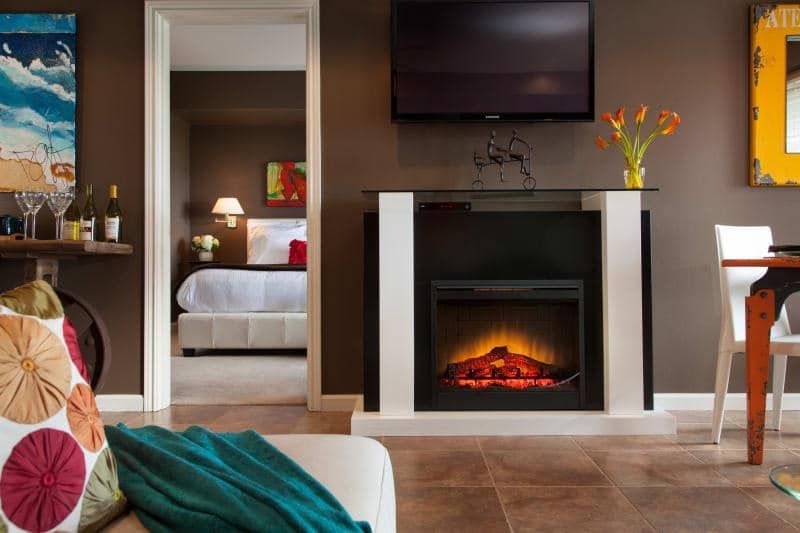 A living room with a fireplace and a flat screen tv