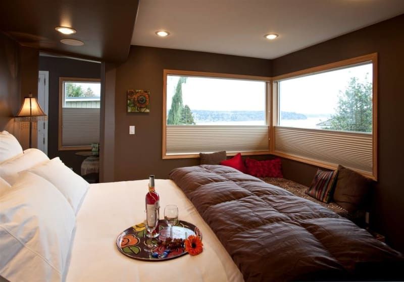 A bedroom with a large bed and a large window