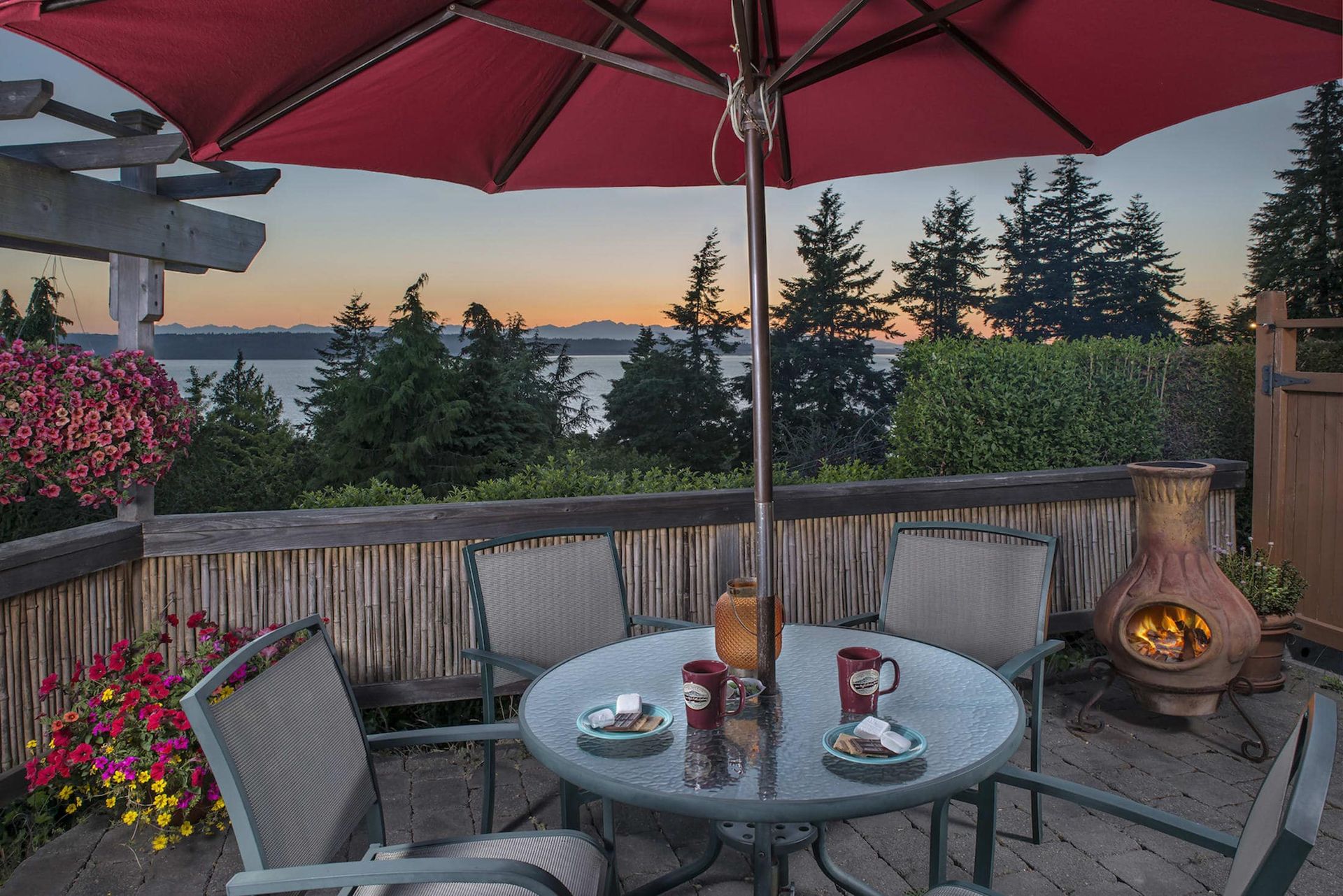 A patio with a table and chairs under an umbrella