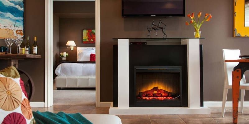 A living room with a fireplace and a flat screen tv.