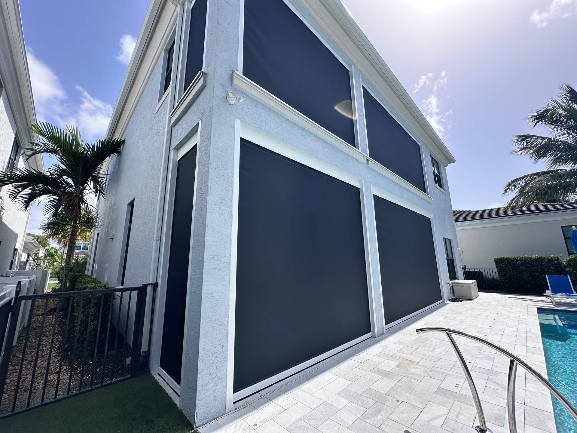 MagnaTrack™ Defender Hurricane Screen Shades on a home's patio near Ft. Lauderdale, Florida (FL)