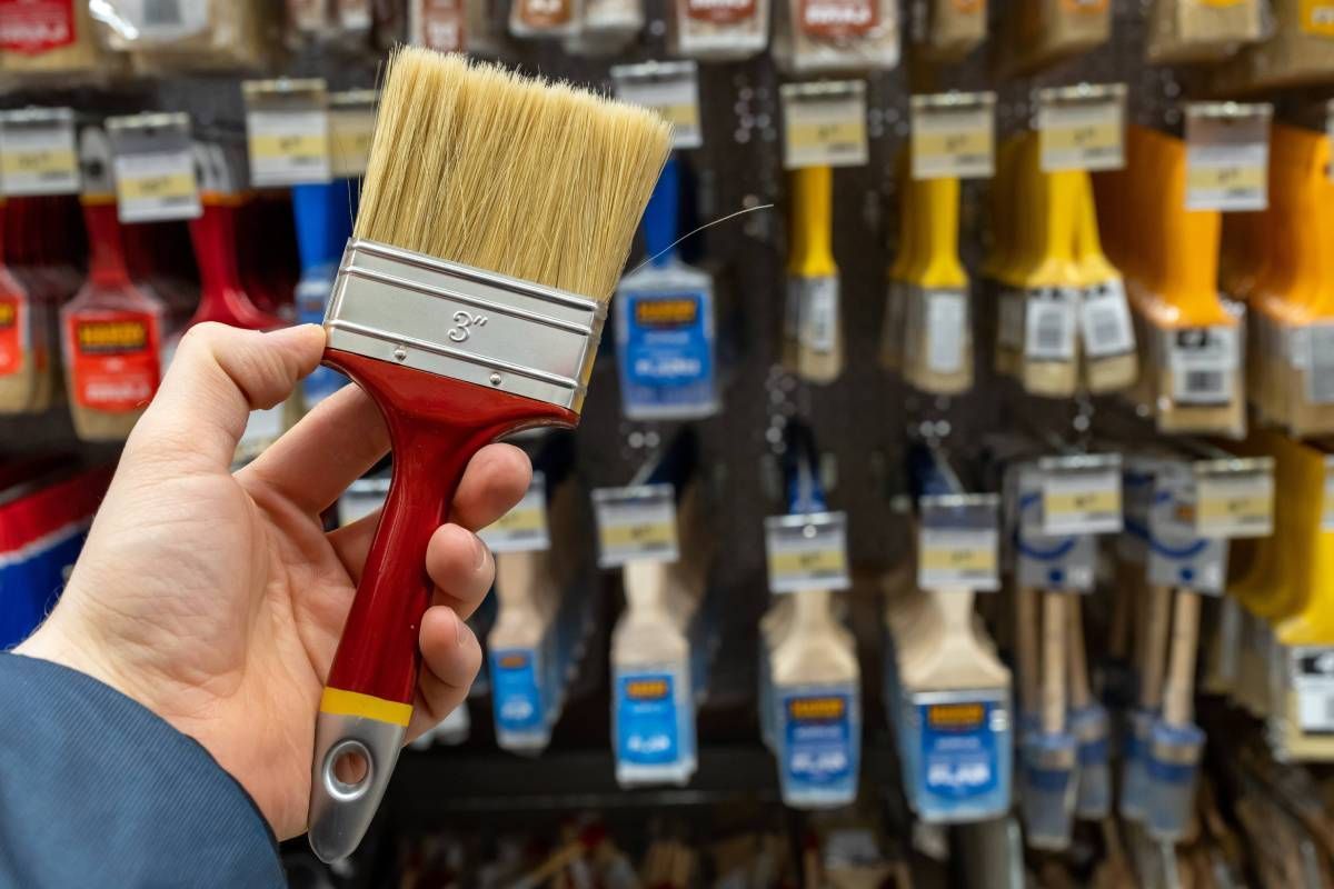 A professional painter buying tools at a professional paint center near the Caribbean