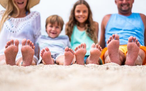 Family legs at the beach