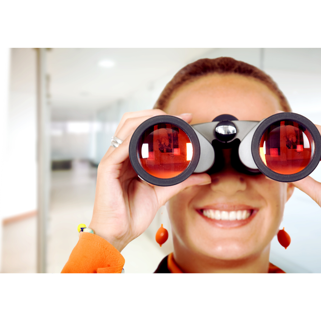 a woman is smiling while looking through binoculars