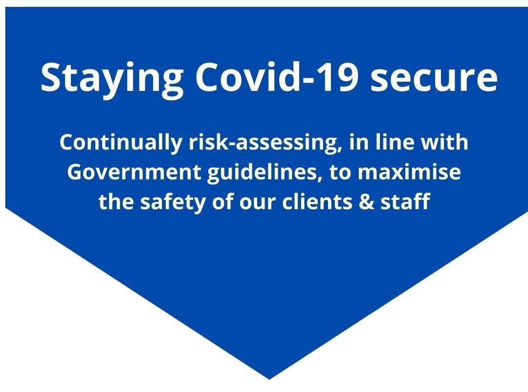a blue sign that says staying covid-19 secure