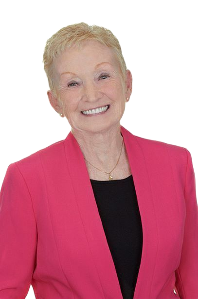 A woman in a pink jacket and black shirt is smiling.