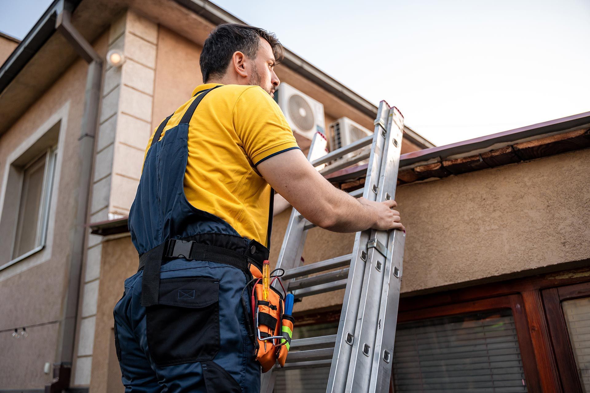 A man is inspecting a roof.