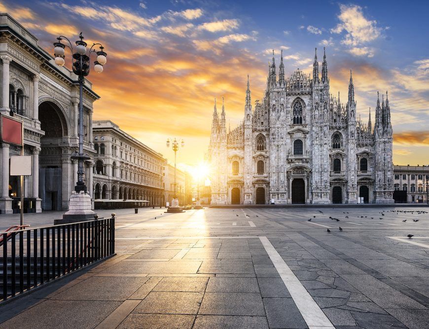 Milan Cathedral and buildings at sunrise.