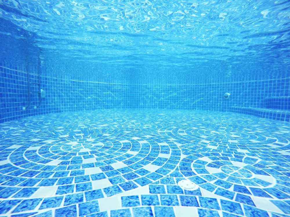 Underwater View of An Empty Swimming Pool with Blue Tiles — Sun Cool Pools & Spas in Maryborough, QLD