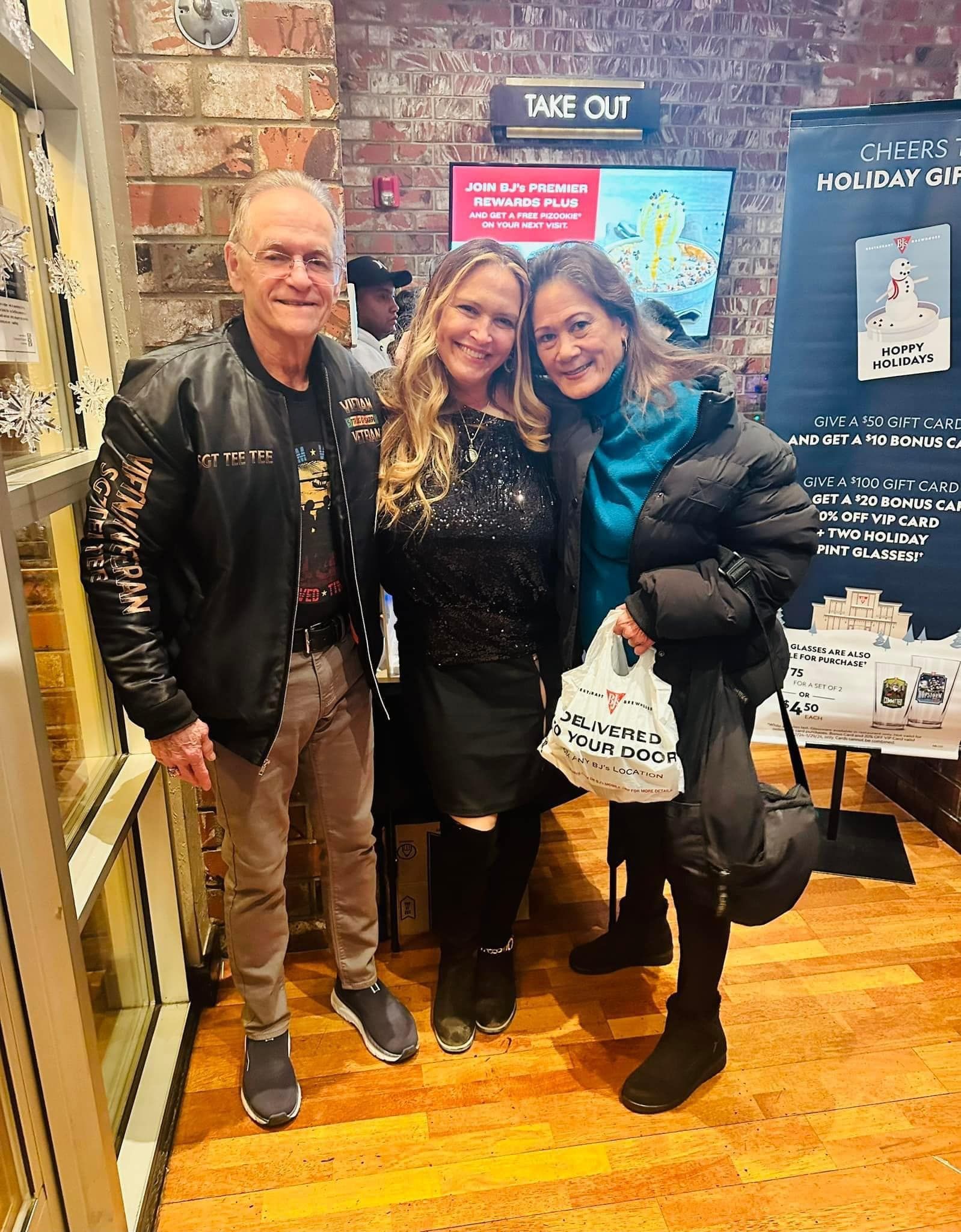 A man and two women are posing for a picture in a store.