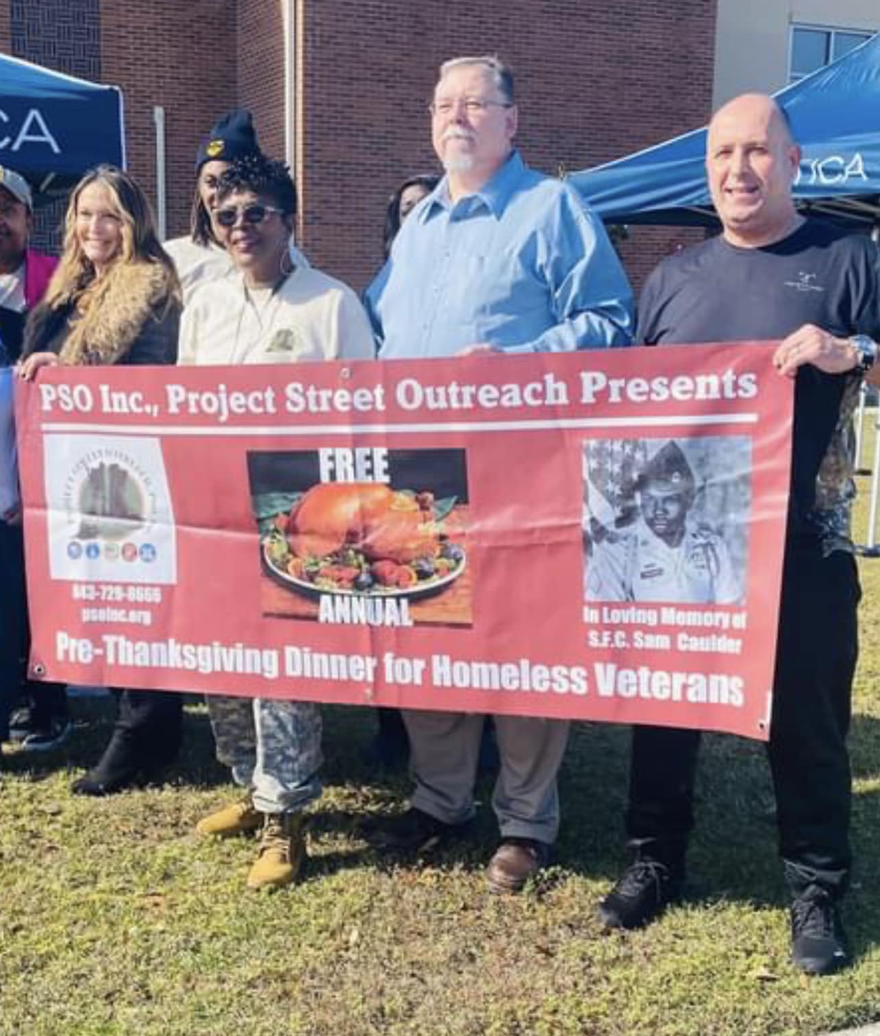 A group of people holding a sign that says project street outreach presents