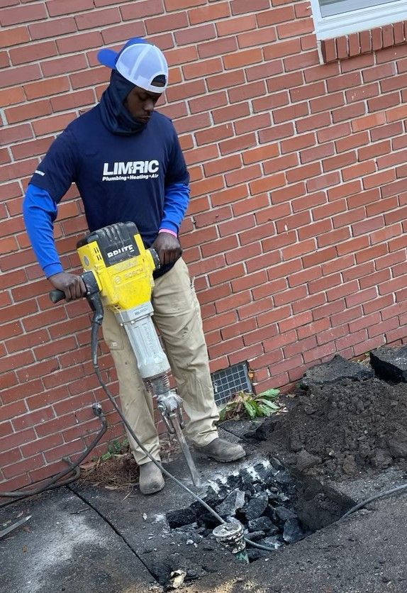 A man is using a hammer to break a hole in the ground.
