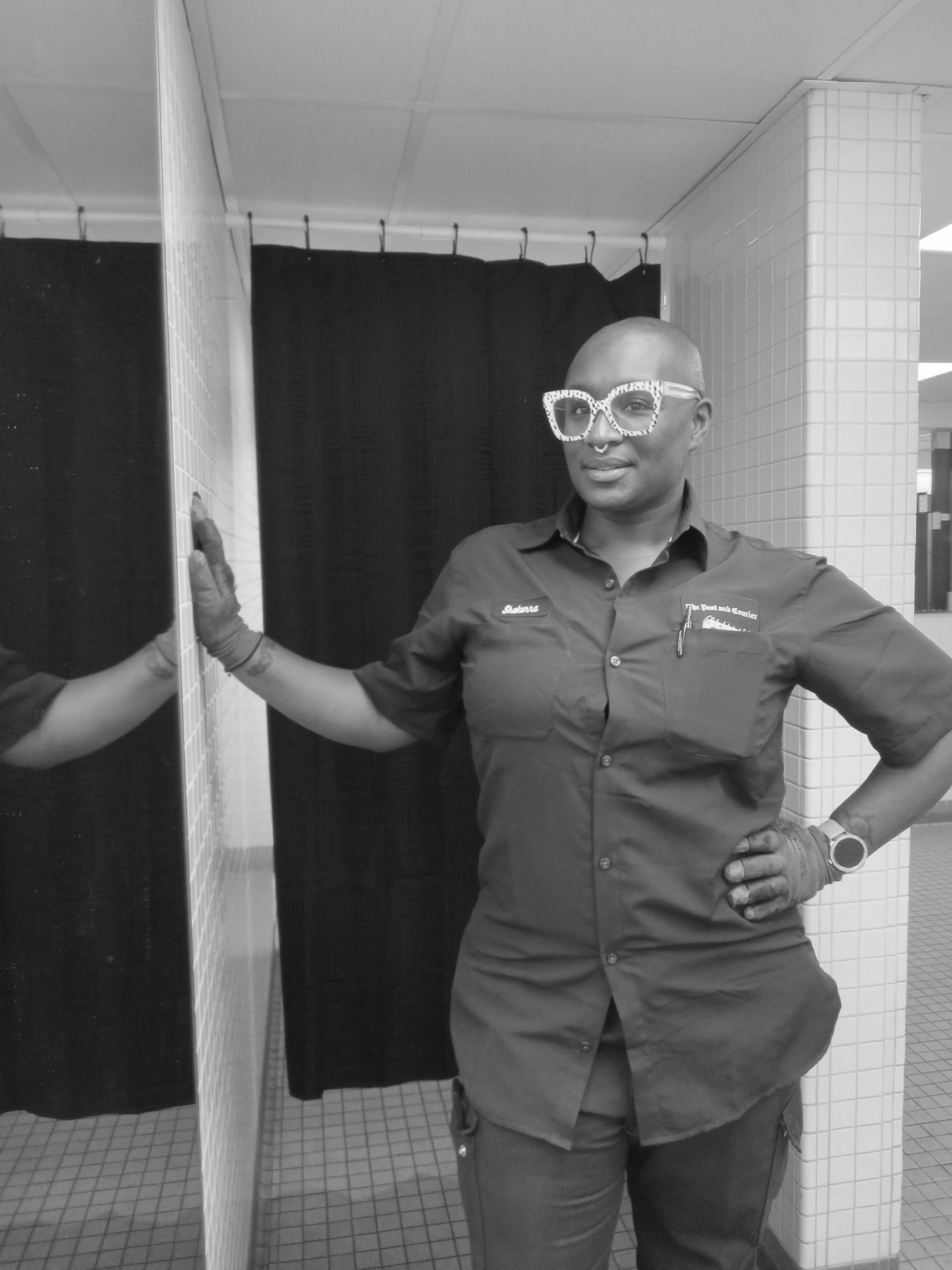 A black and white photo of a woman in a dressing room