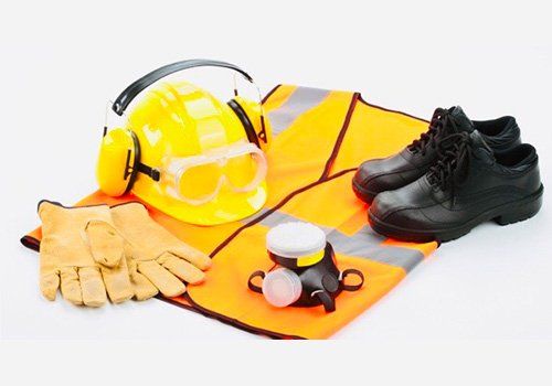 A safety vest , helmet , gloves , shoes , goggles and ear muffs on a white background
