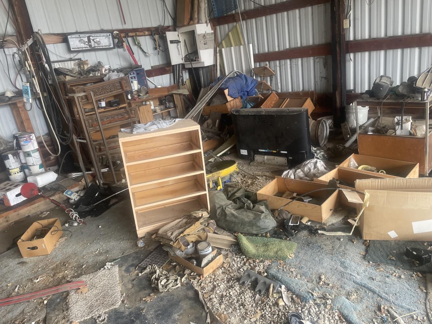 a row of trash cans are lined up in front of a brick building .