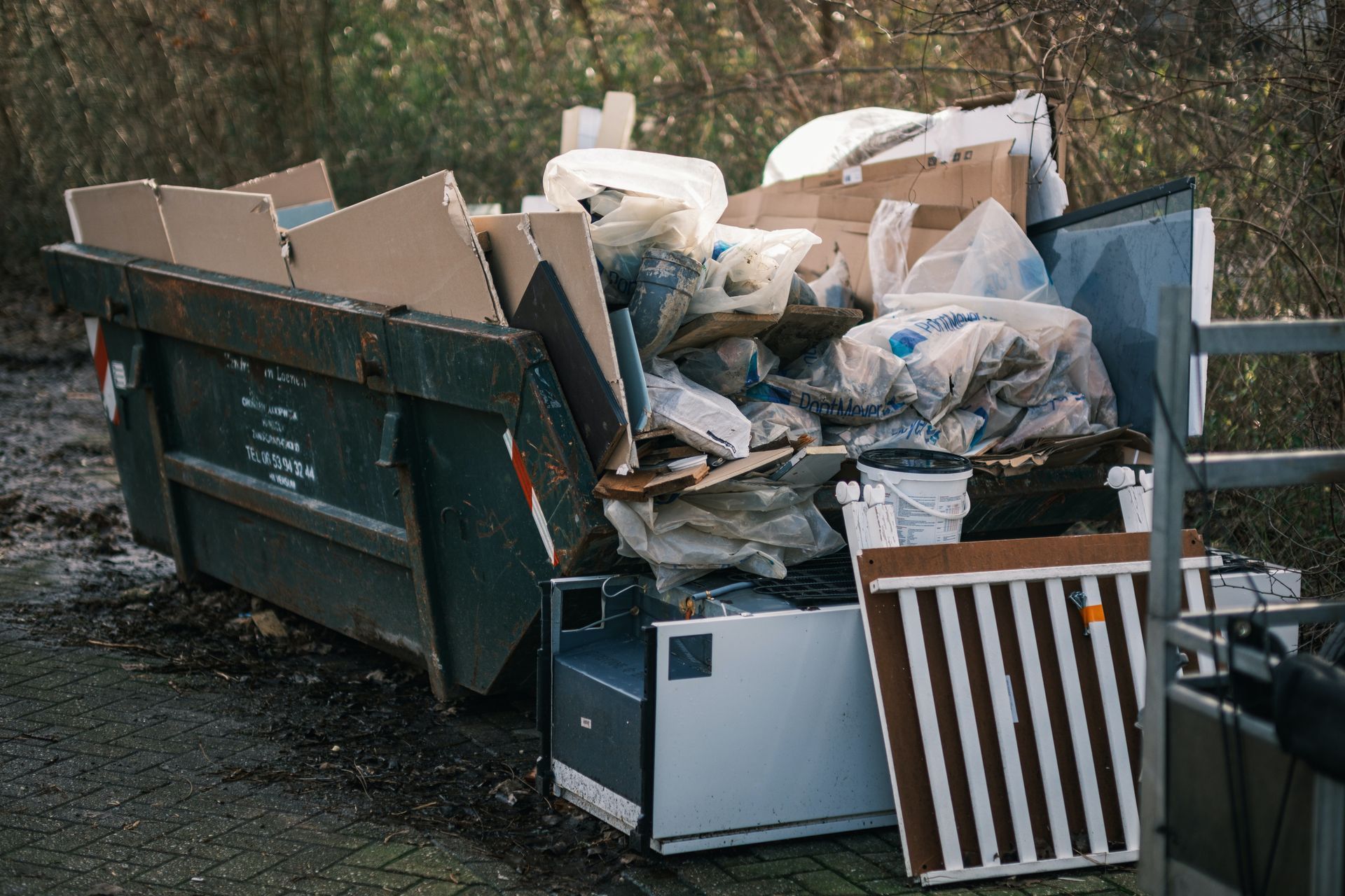 a dumpster filled with a lot of trash and junk .