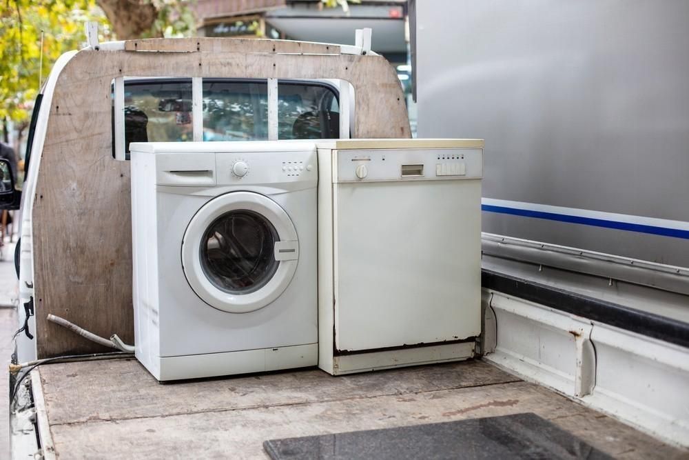 a washing machine and a dishwasher are in the back of a truck .