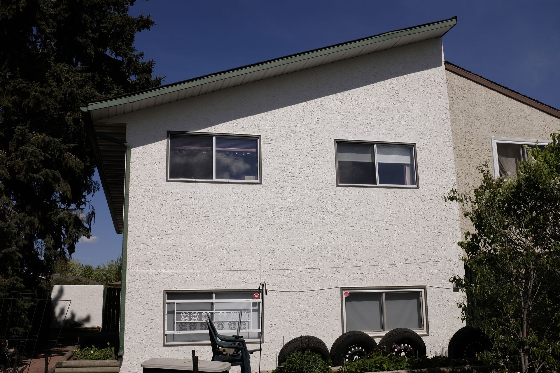 A white house with a green roof and a sign that says ' a ' on it