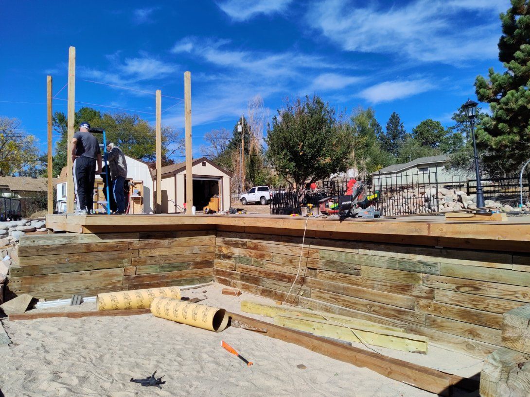 A group of people are standing on top of a wooden structure.
