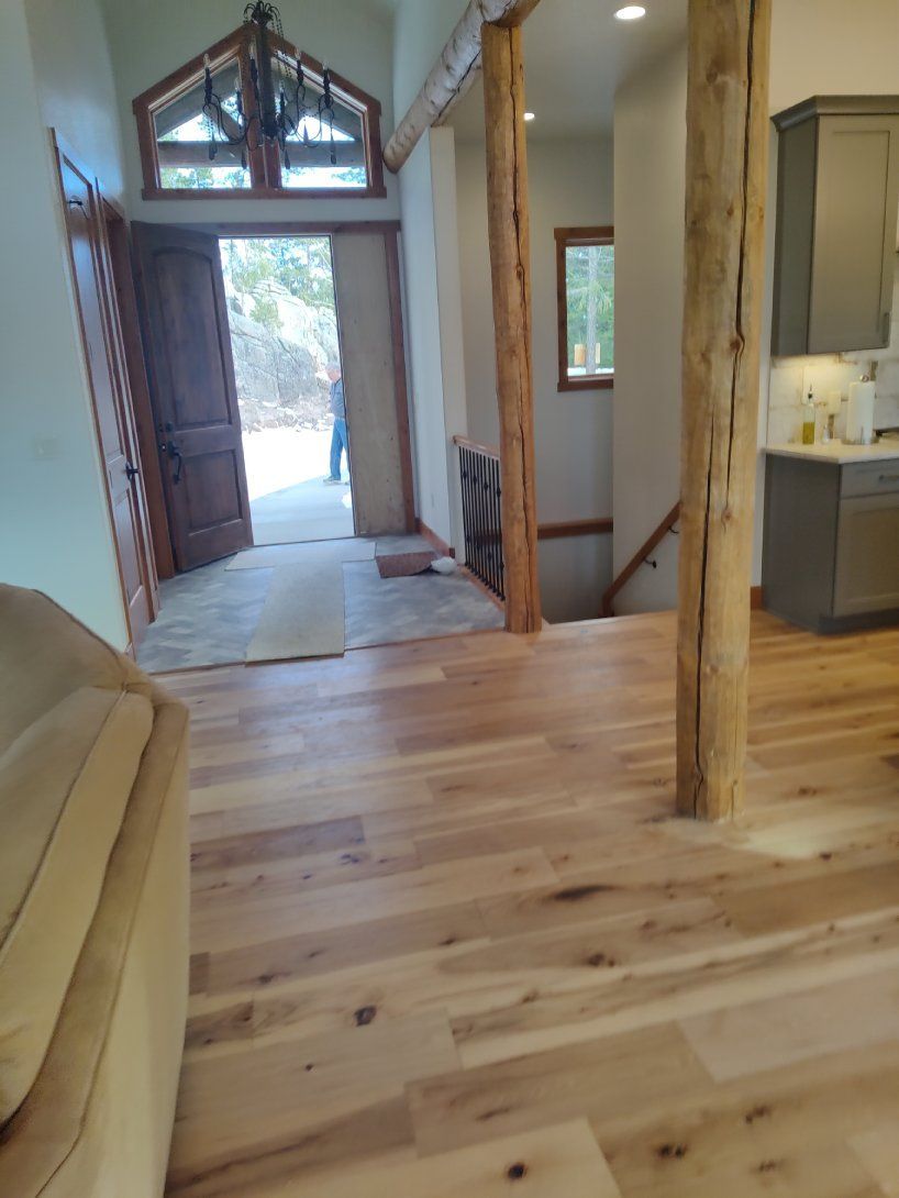 A living room with hardwood floors and a couch.