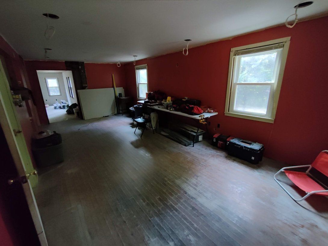 A large room with red walls and wooden floors.