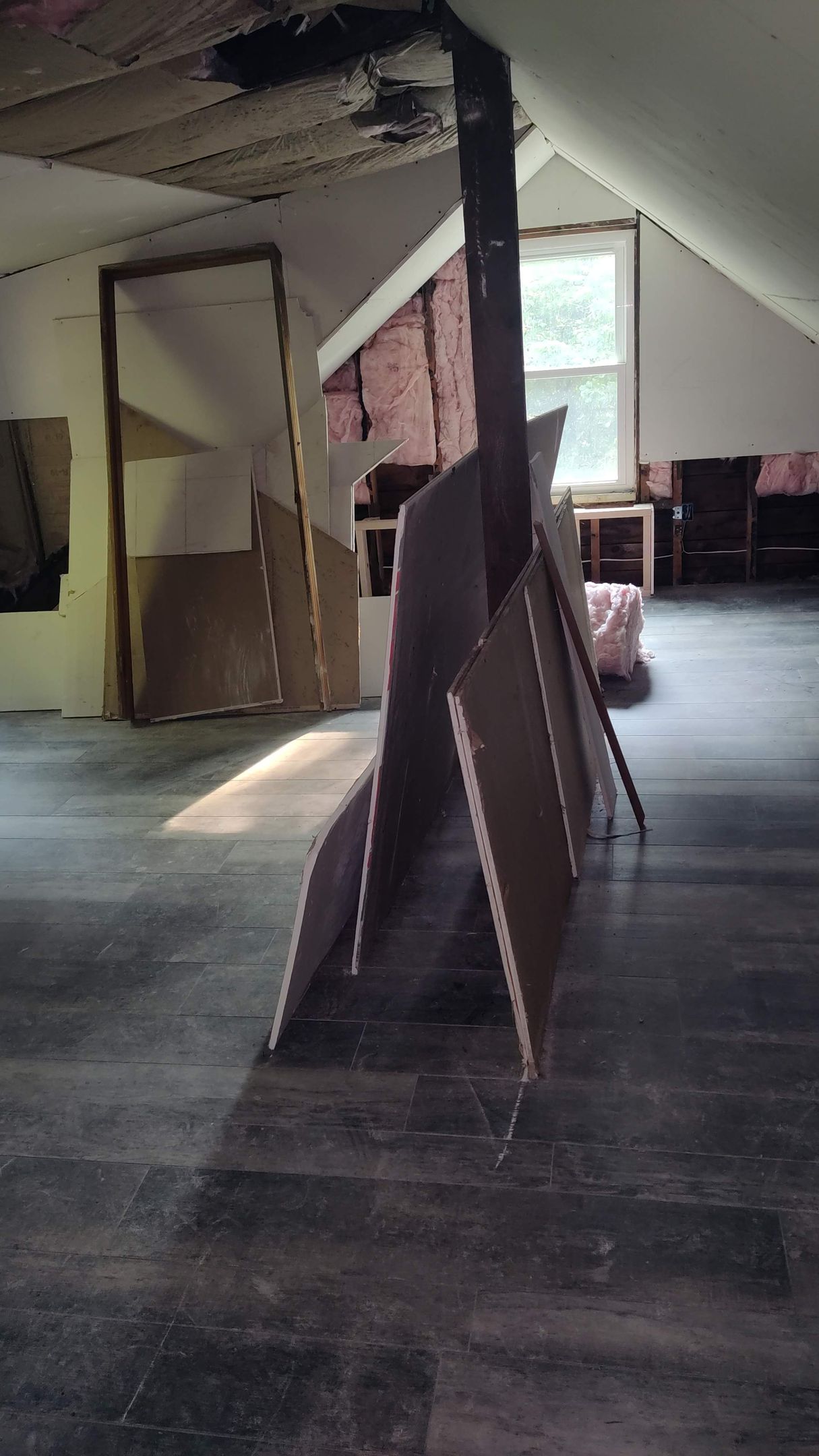 A room with a lot of cardboard boxes on the floor.