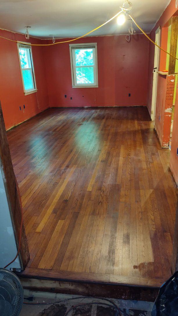 A room with a wooden floor and red walls.