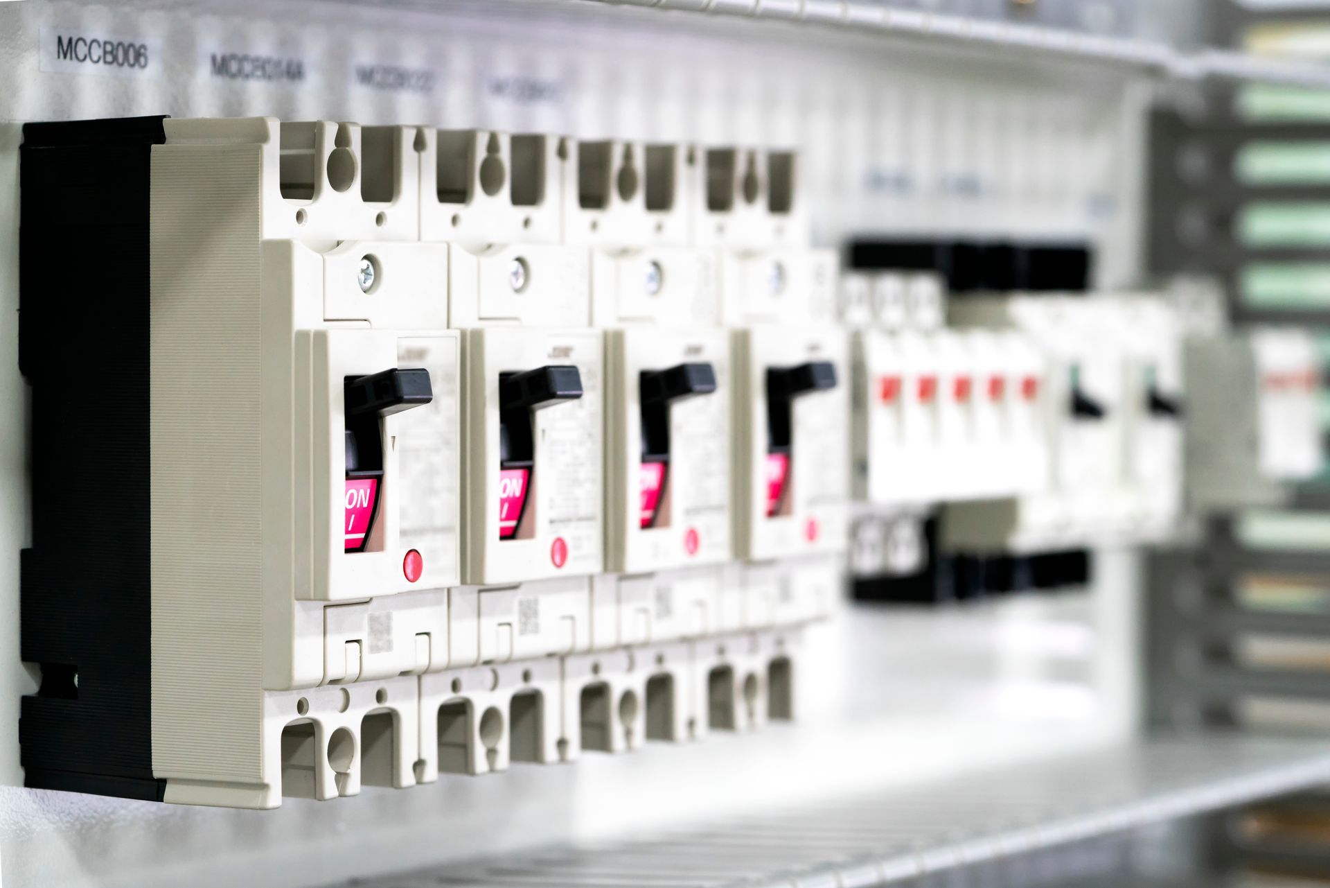A close up of a row of electrical boxes on a shelf.