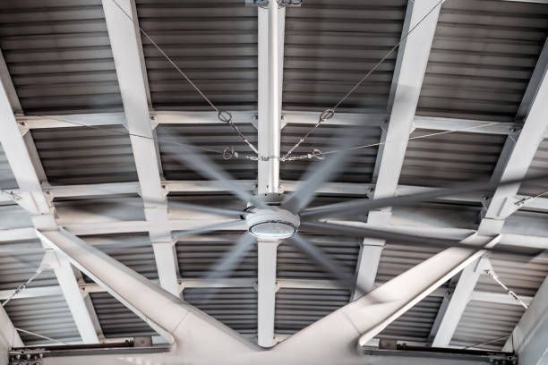 A large ceiling fan is hanging from the ceiling of a building.
