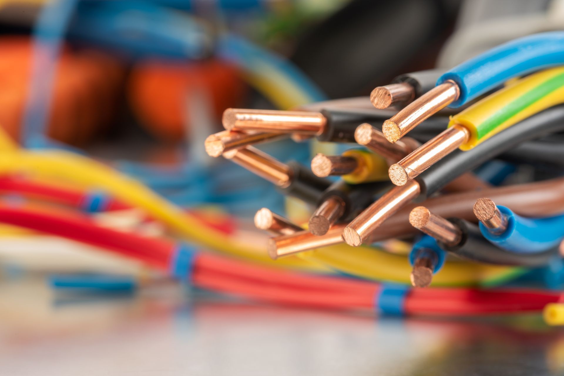 A bunch of colorful electrical wires are sitting on a table.