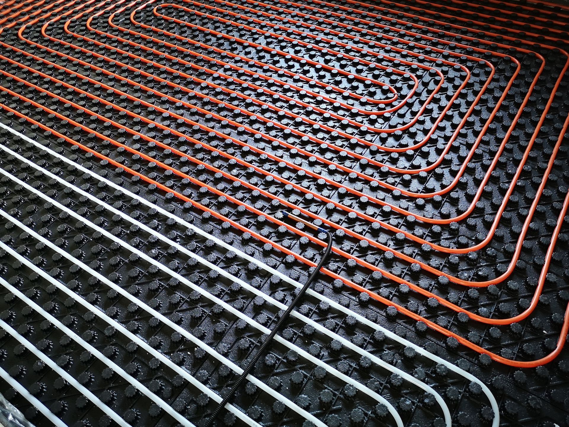 A close up of a heating system on a floor.