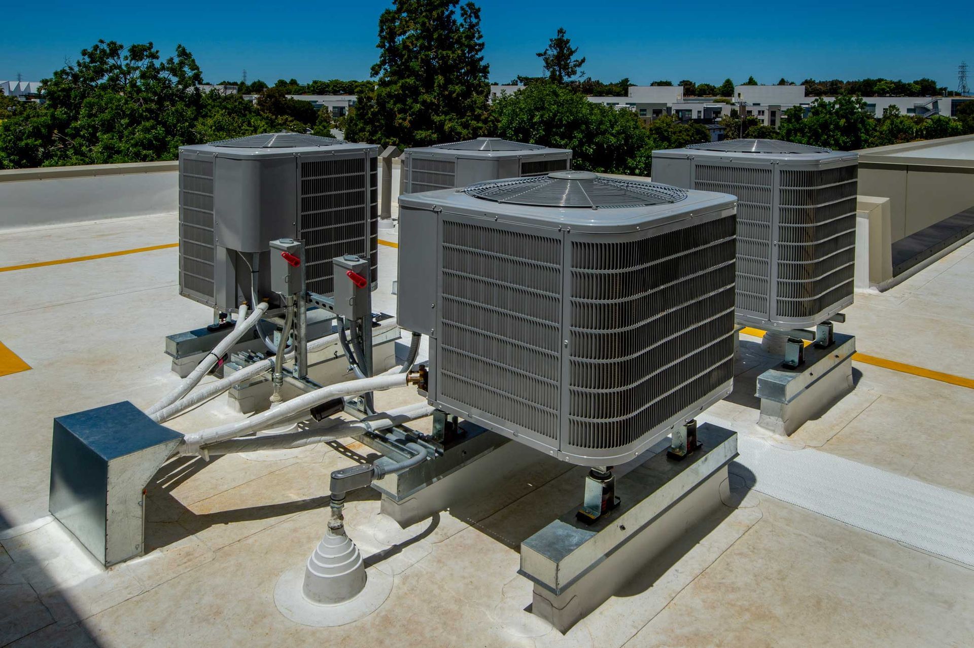 A group of air conditioners are sitting on top of a roof.