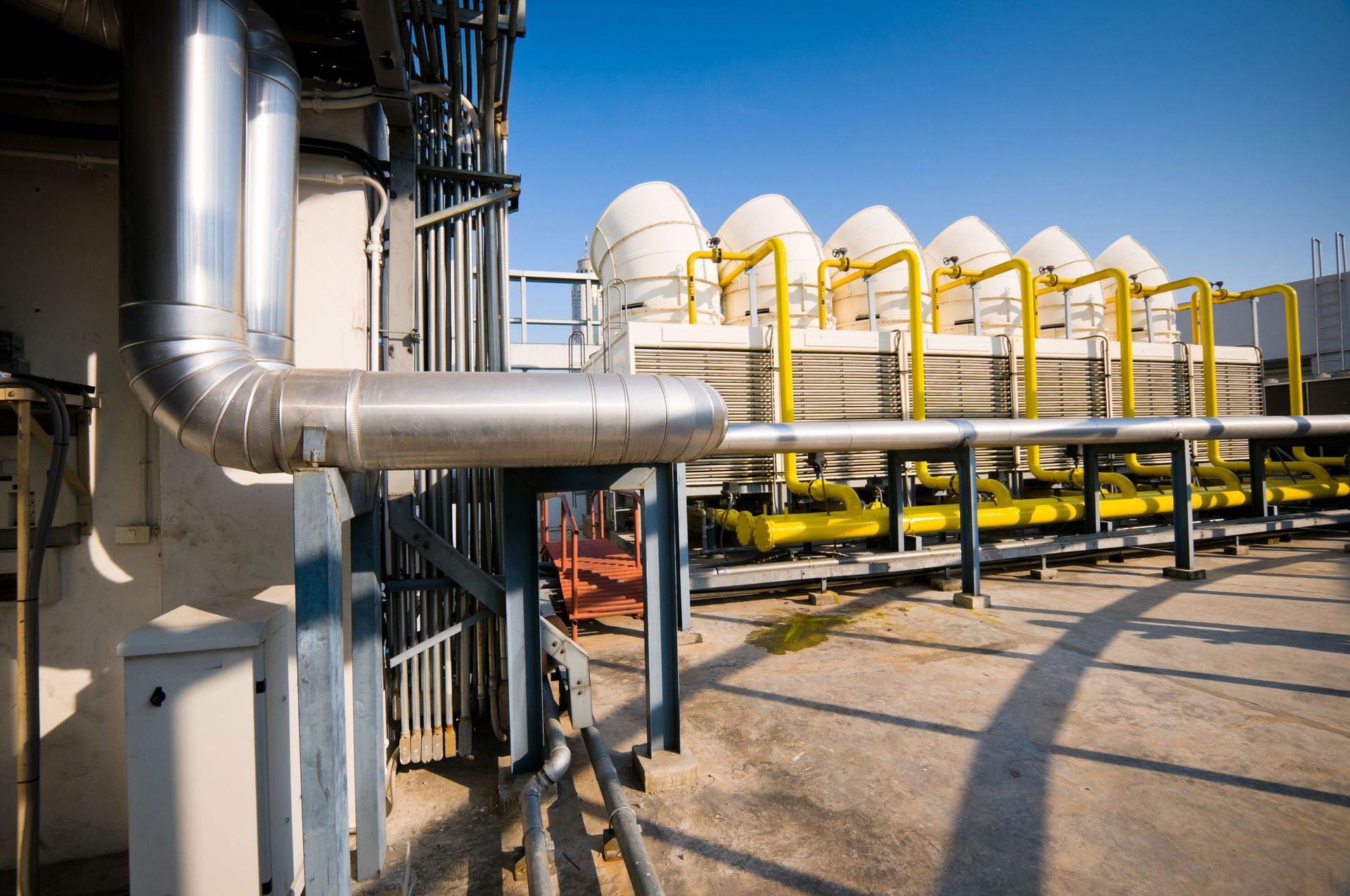 A row of pipes are lined up outside of a building.