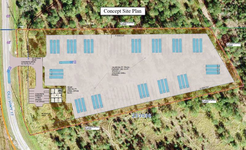 An aerial view of a parking lot surrounded by trees