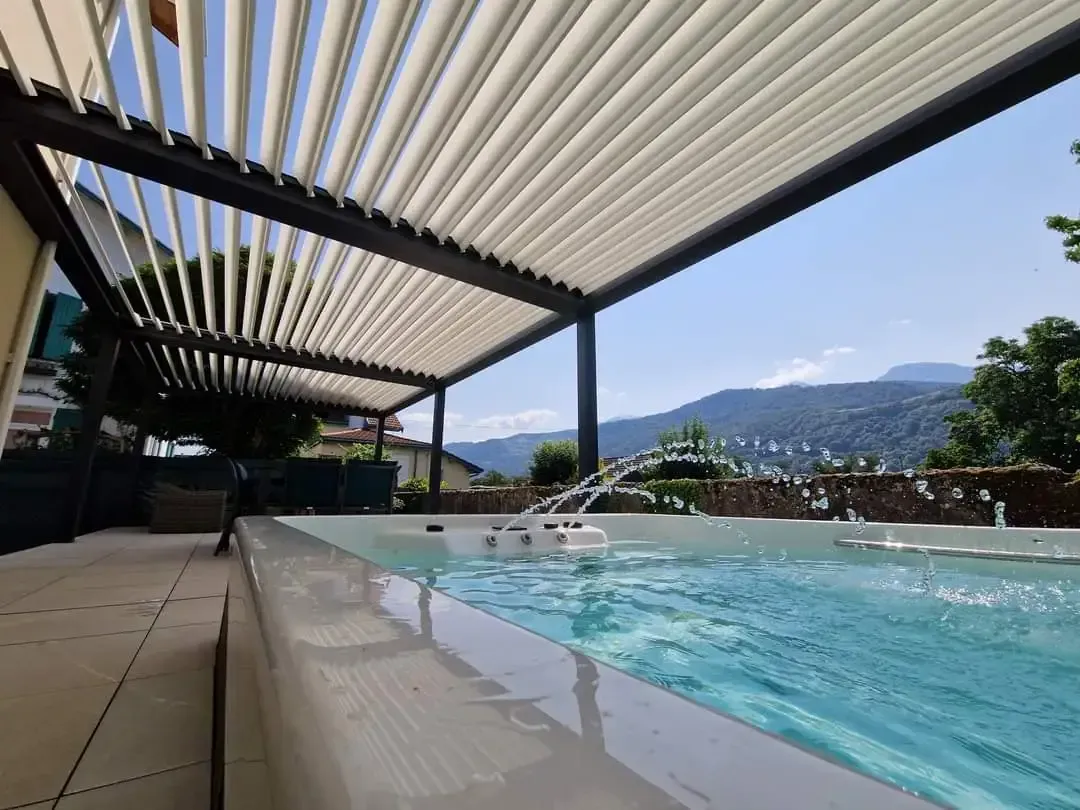 une piscine entourée d' une pergola avec une vue sur les montagnes .