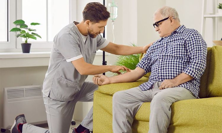 a nurse is giving an elderly man an IV