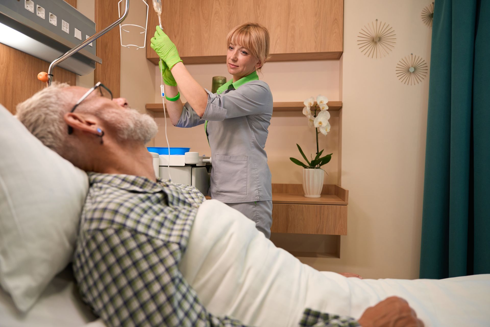 Experienced nurse prepares an IV for an elderly man