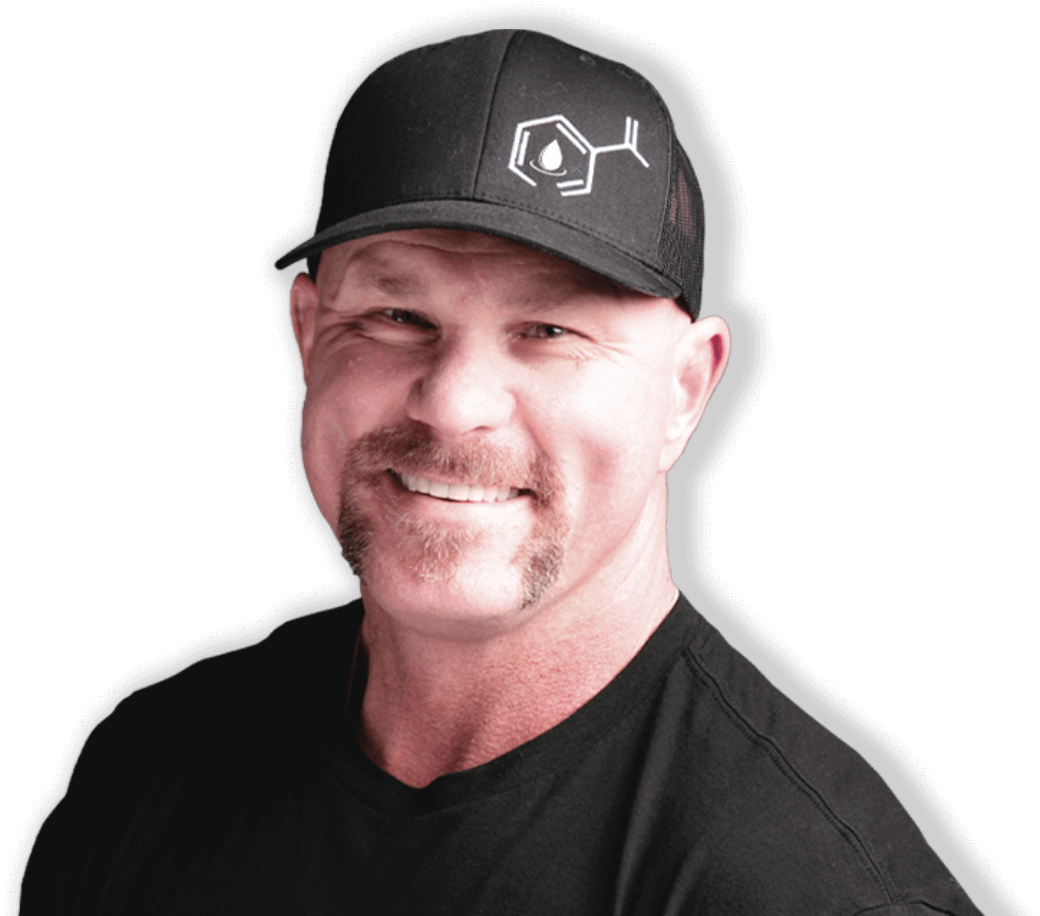 A man wearing a black hat and a black shirt is smiling