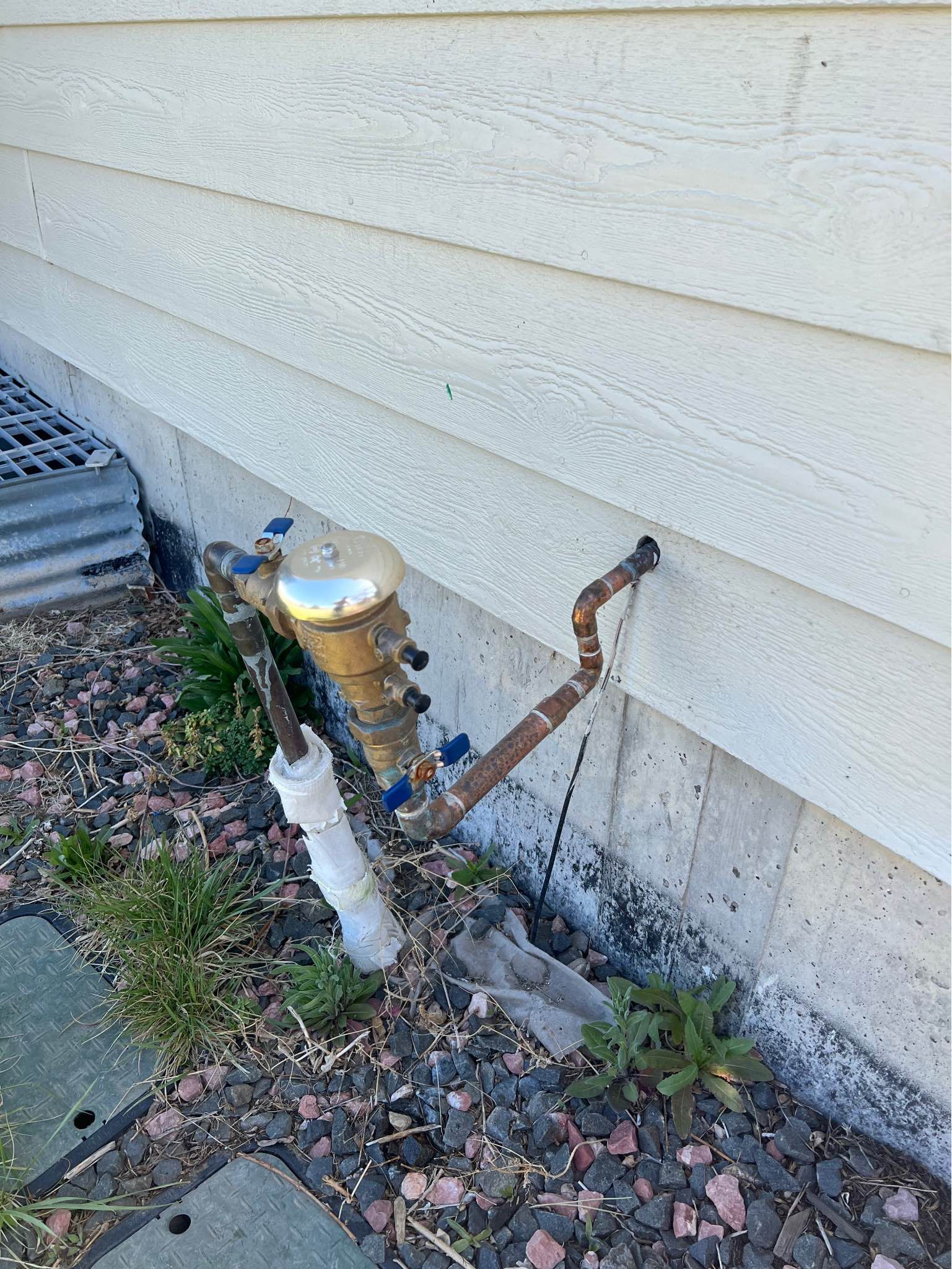 A close up of a faucet on the side of a house.