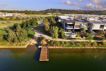 An Aerial View of a Large House Next to a Body of Water — Core Pest Management in Maroochydore, QLD