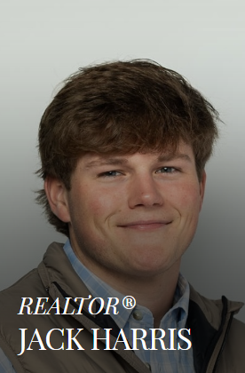 Jack Harris, Realtor, smiling. Wearing a button-down shirt and vest.