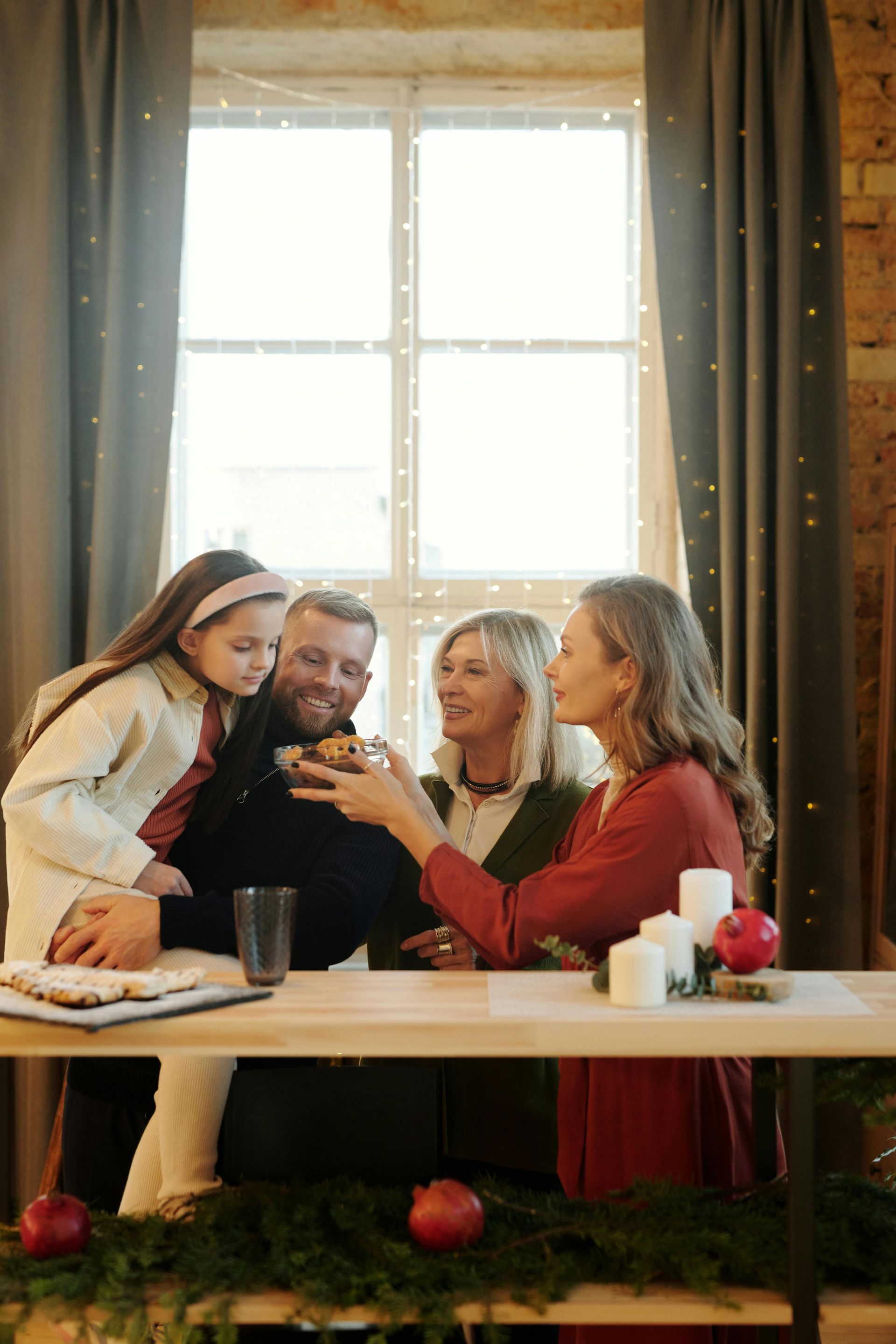 A family is sitting at a table celebrating christmas.