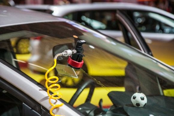 tool stuck on windshield and yellow cable conncted to the tool